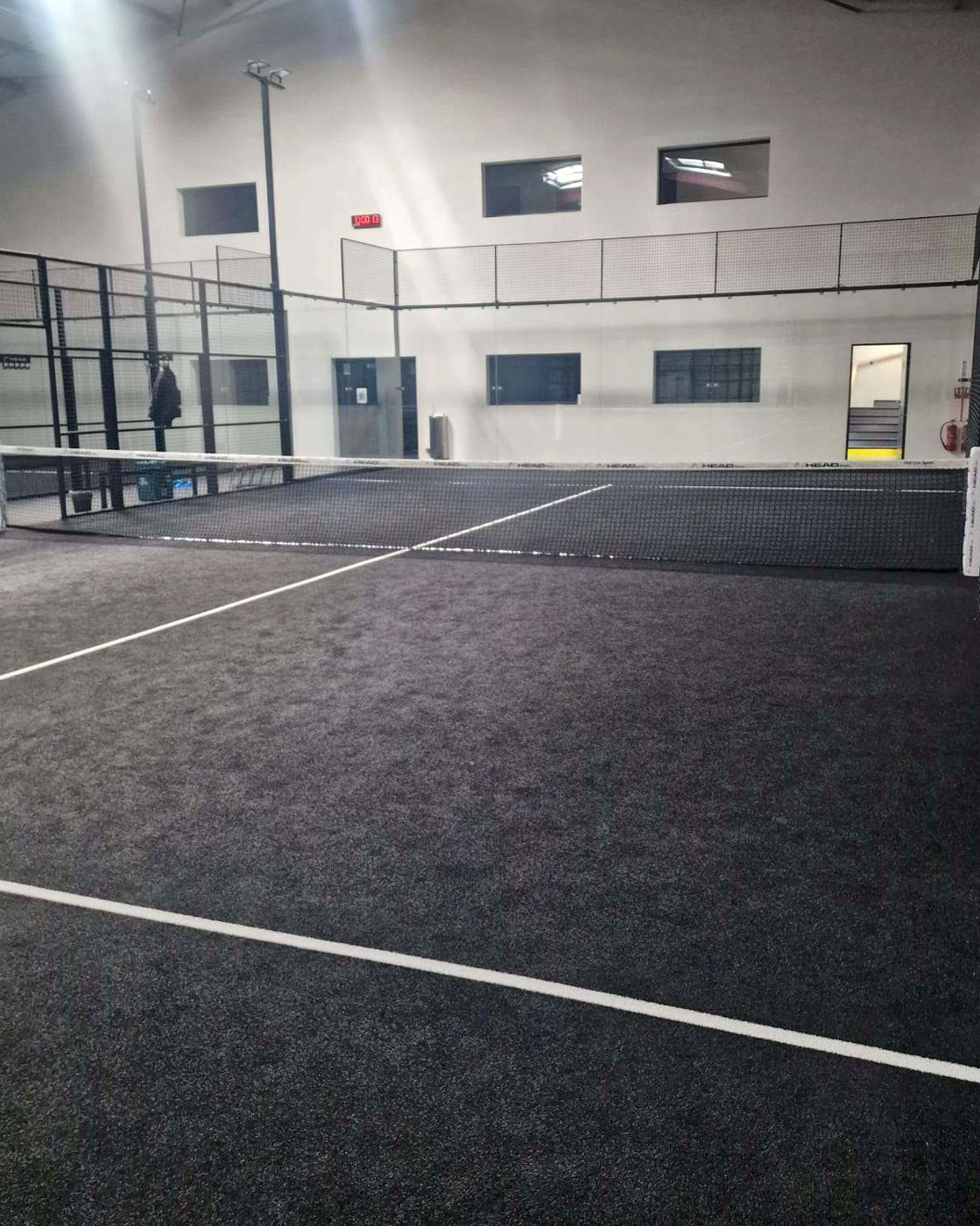 Indoor black-turf padel court installed by AGEPADEL at Padel Izon